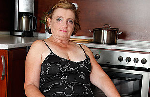 Naughty mature lady playing in the kitchen