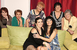 Old and young lesbians perform in a room acting of mature ladies